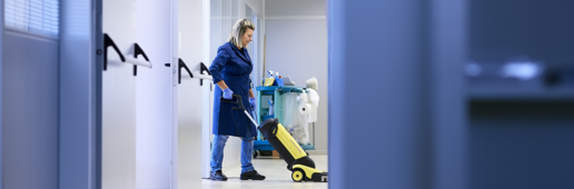 Professional providing restaurant cleaning services in a commercial kitchen.